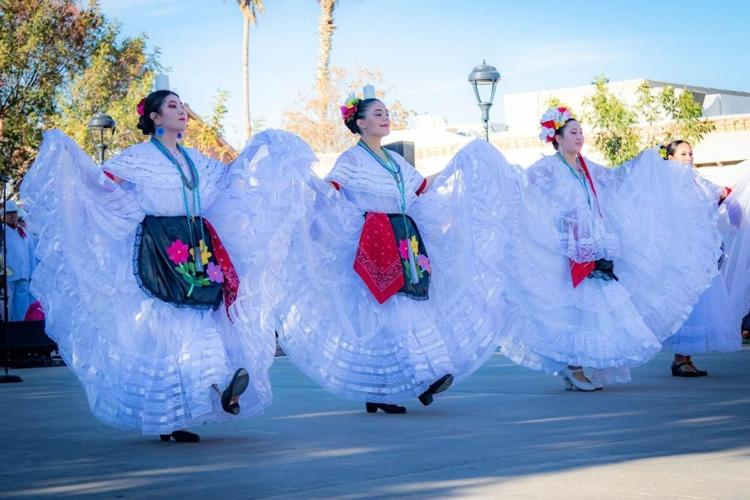 dancing laday in white dress, festival in las cruces
